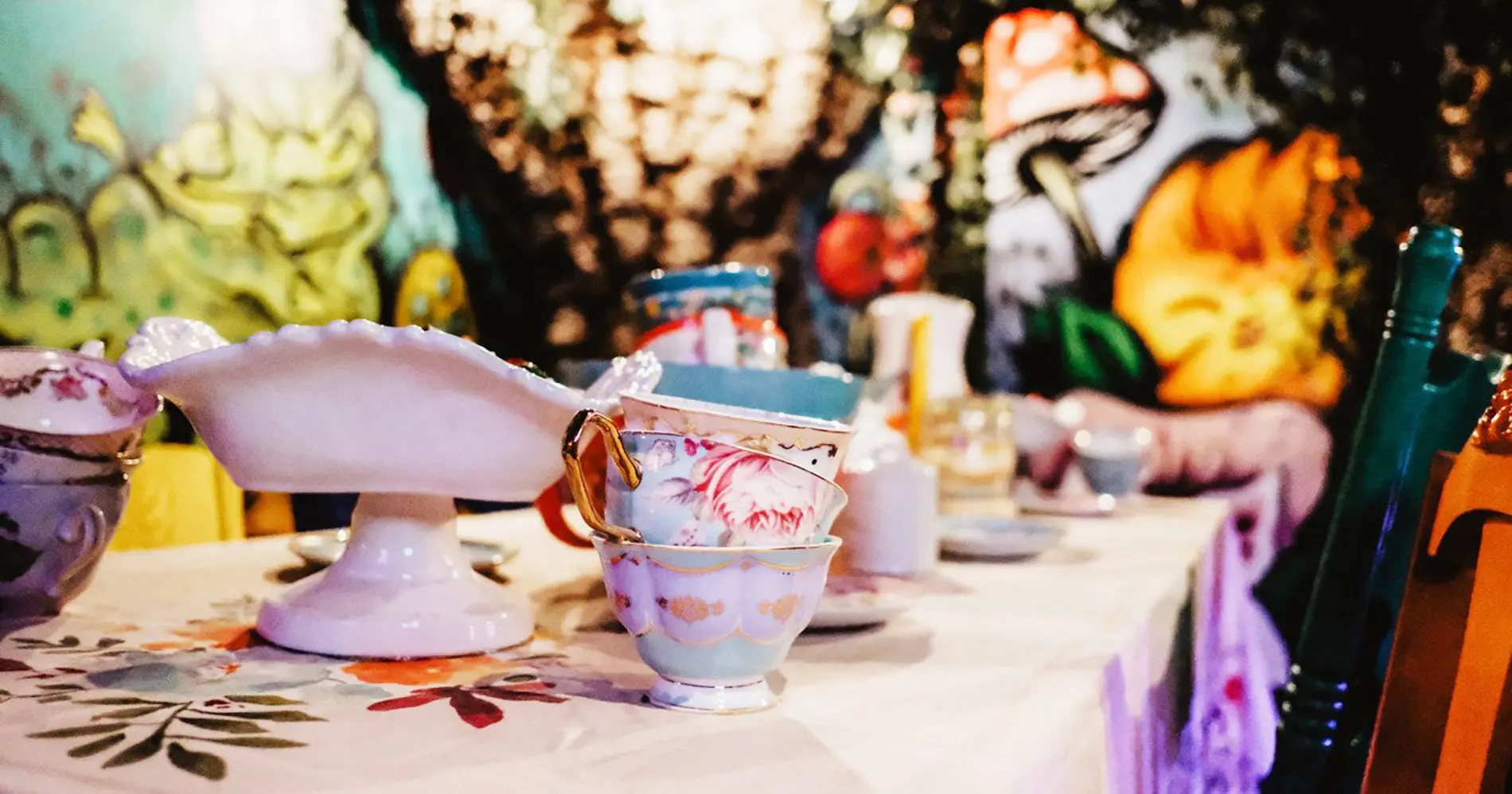 Floral teacups on whimsical table setting.