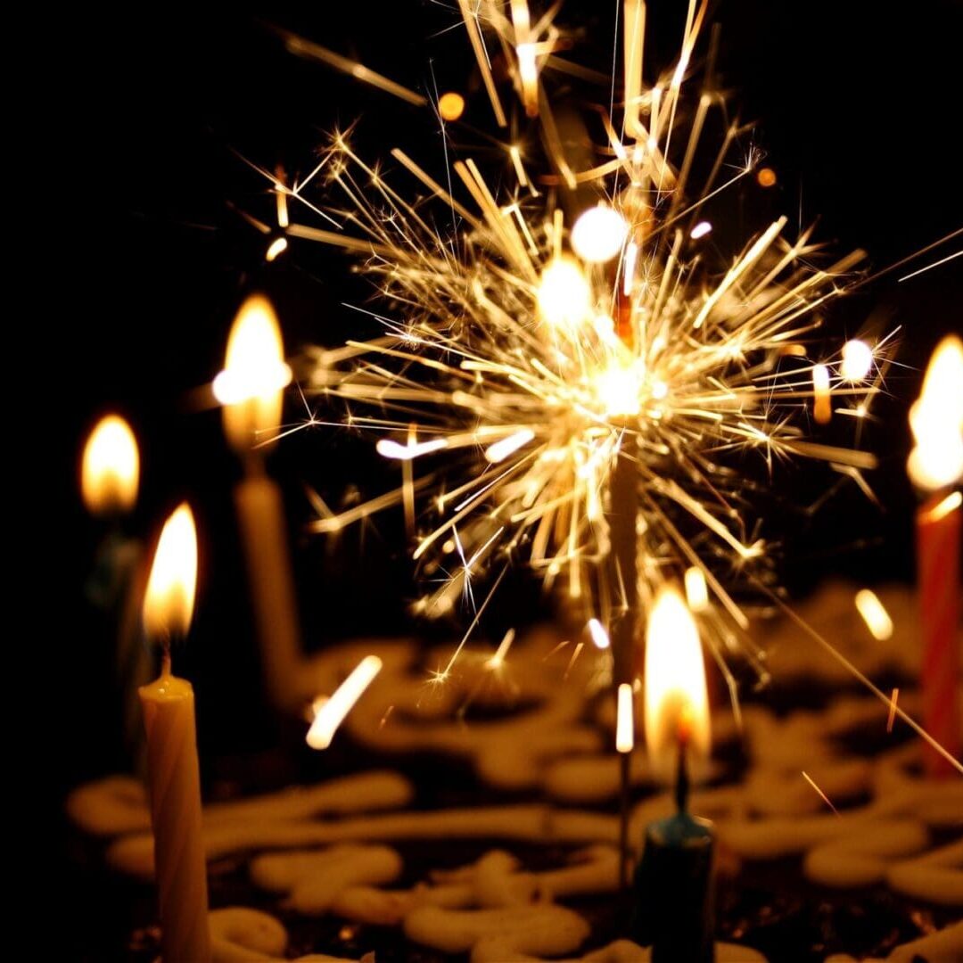 Birthday cake with candles and sparkler.