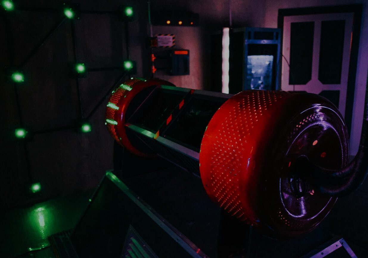 Red futuristic device in escape room.